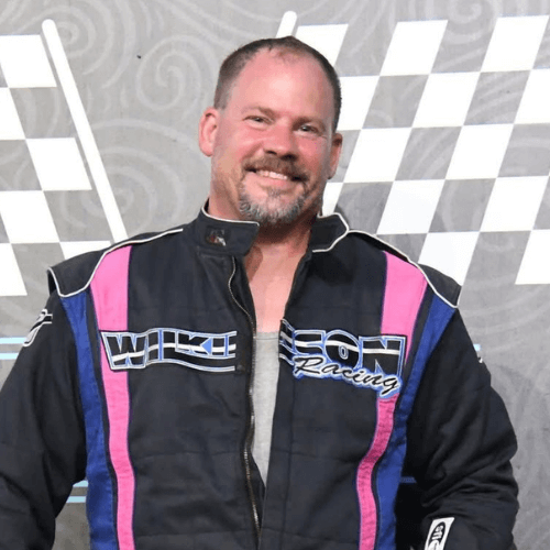 Doug Wilkinson standing on the podium after completing a race